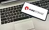 Pure Storage logo on smartphone, laying on a laptop